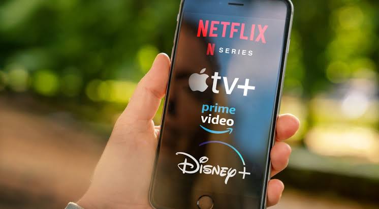 Streaming apps on a smartphone illustrating why the same movie may be recommended differently across streaming platforms based on personalized algorithms.